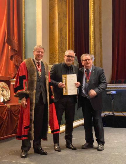 Pictured here - Tom receiving his certificate from Prime Warden of the Goldsmiths' Company, Dr Timothy Schroder, and Deputy Warden of the Assay Office, Dr Robert Warden.