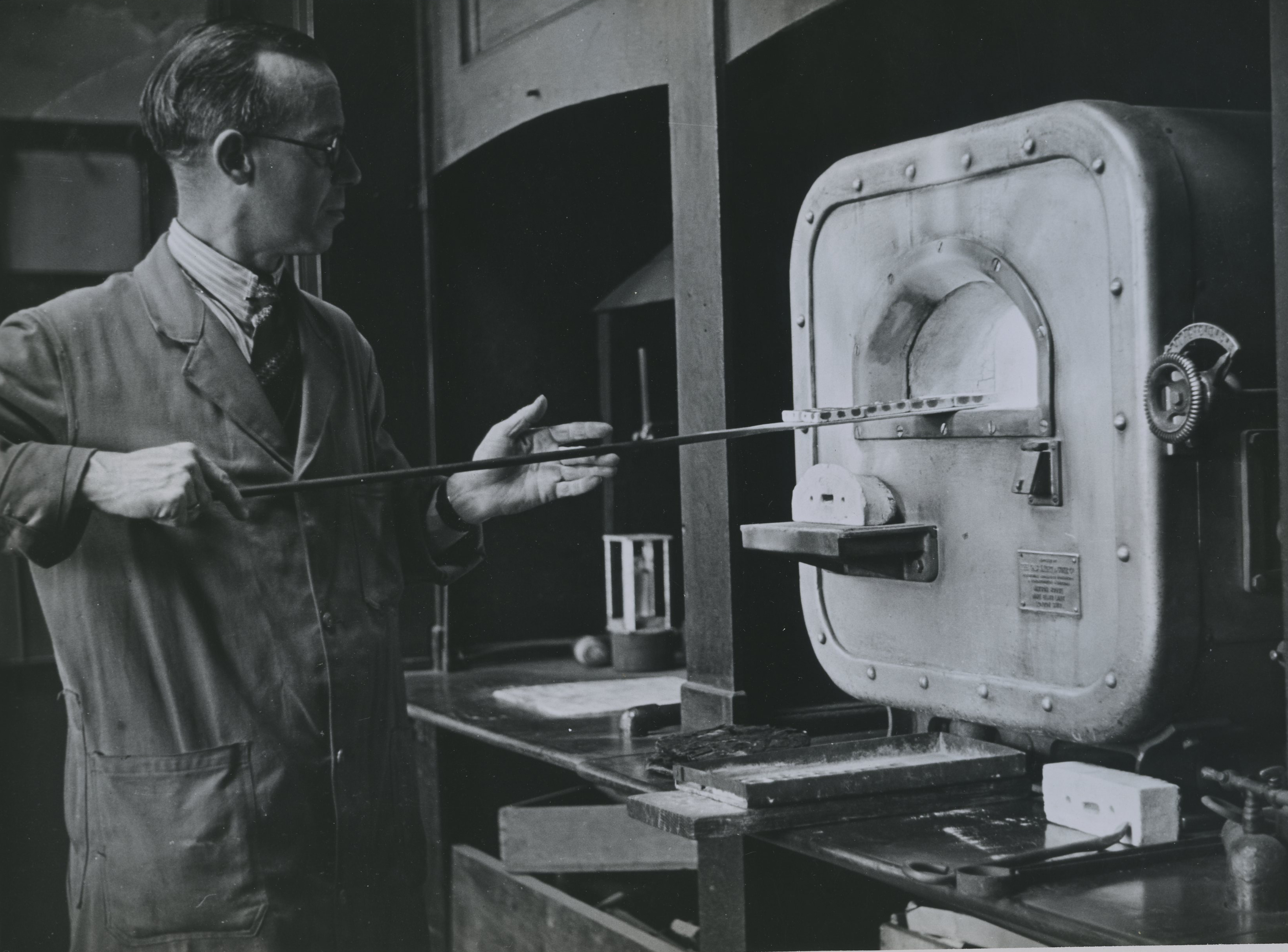 Laboratory - cupels being placed inside the furnace circa 1960
